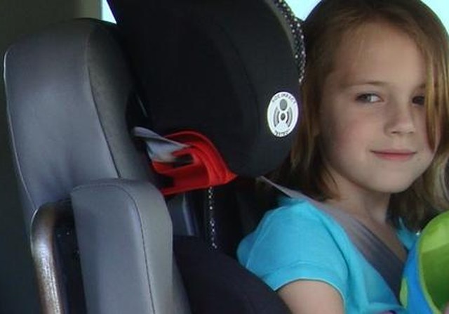 Child buckled into a booster seat